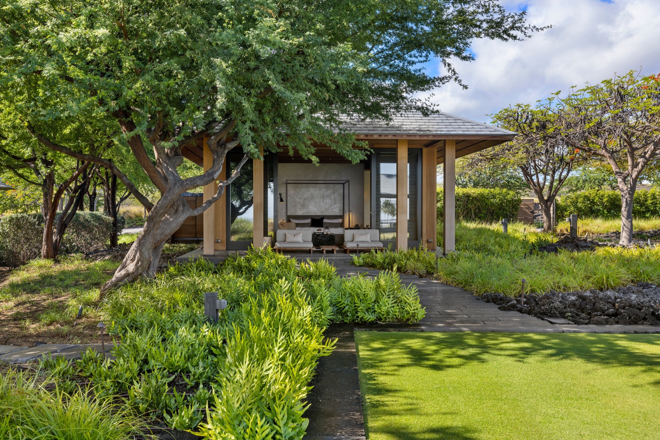 Garden pavilion among trees and lava rock planting, Maniniowali Estate