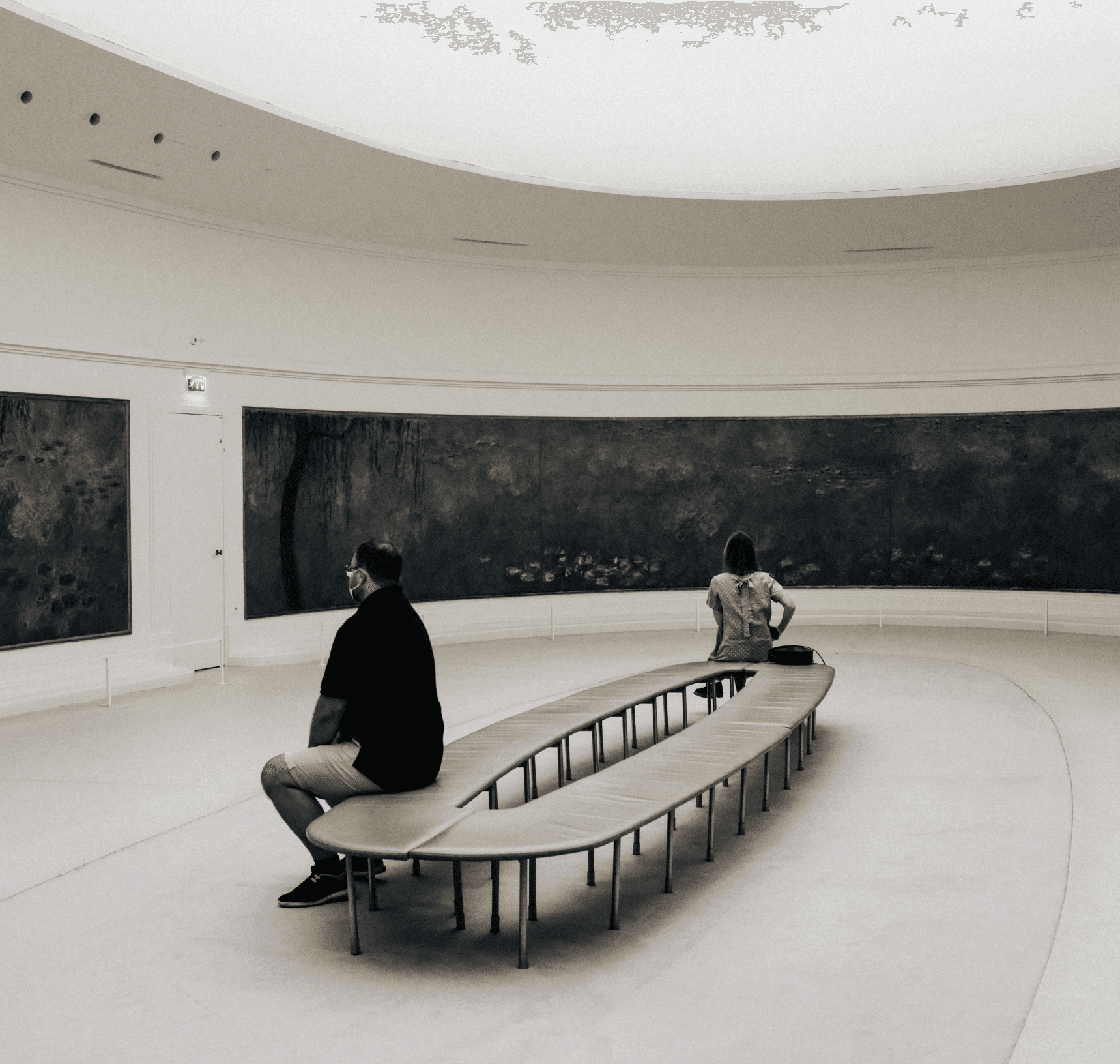 Visitors are viewing painting in gallery.