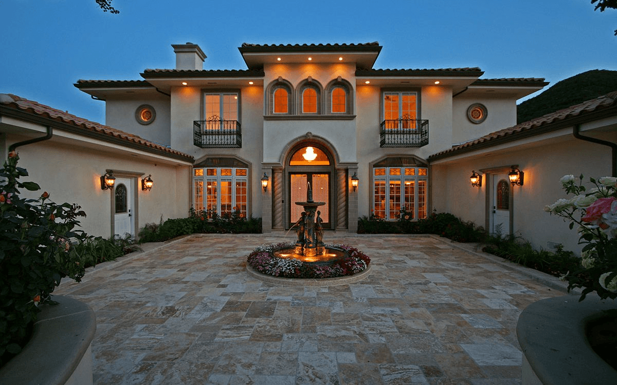 Exterior courtyard with a fountain, featuring lush landscaping and a serene atmosphere.