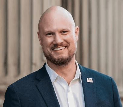 smiling woman wearing white and black pinstriped collared top