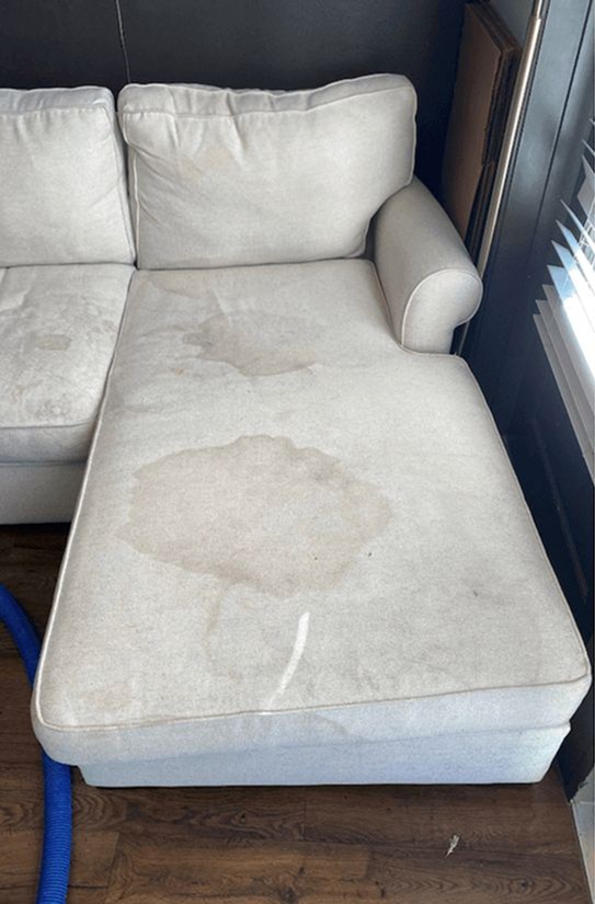 man in gray hoodie and blue denim jeans standing on brown wooden parquet flooring