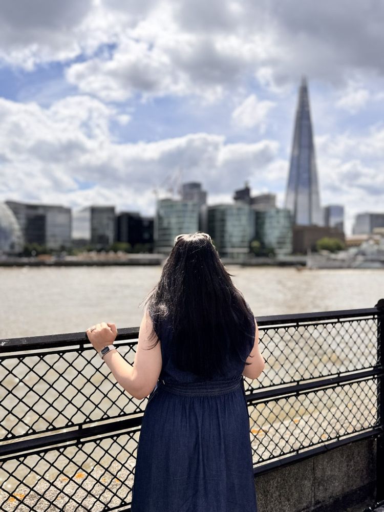 Karishma looking out over the river toward the city skyline