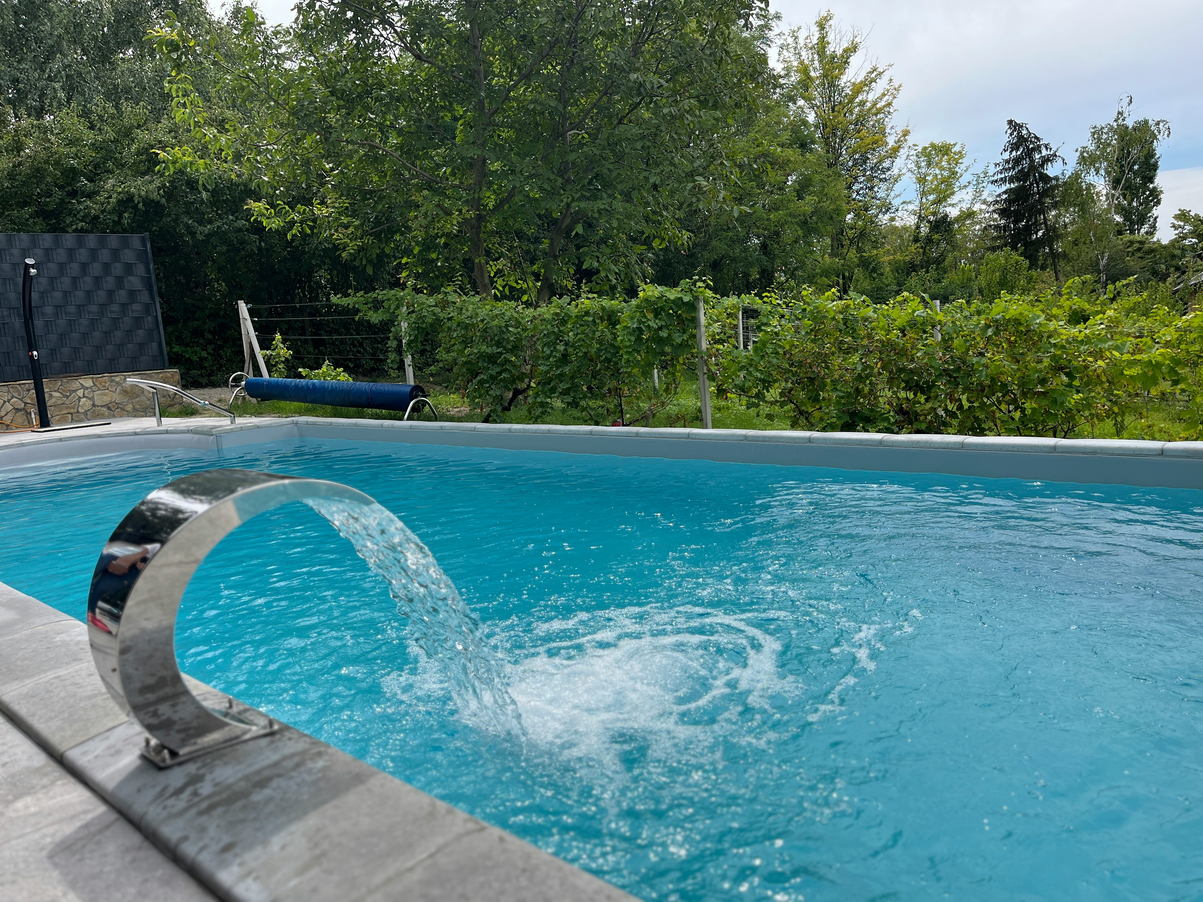 a blue swimming pool with a water spout