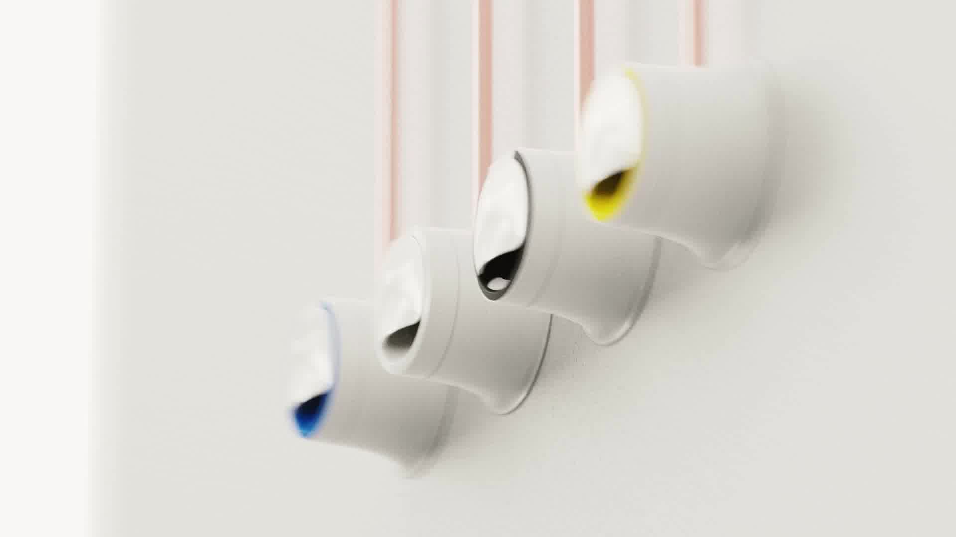 Ensemble de prises murales fermées, avec leurs jupes de différentes couleurs, et des tubes en cuivre dépassant par le dessus.