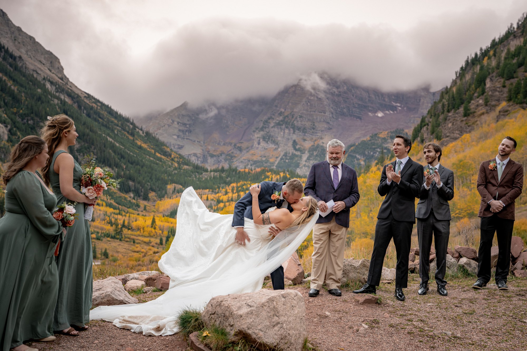 Groom dipping the bride for a kiss at their Maroon Bells wedding ceremony