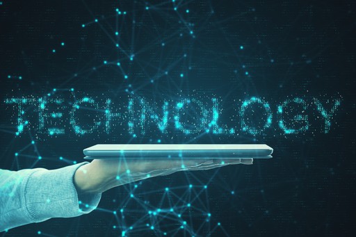 man holding a tablet with the words technology floating over it.
