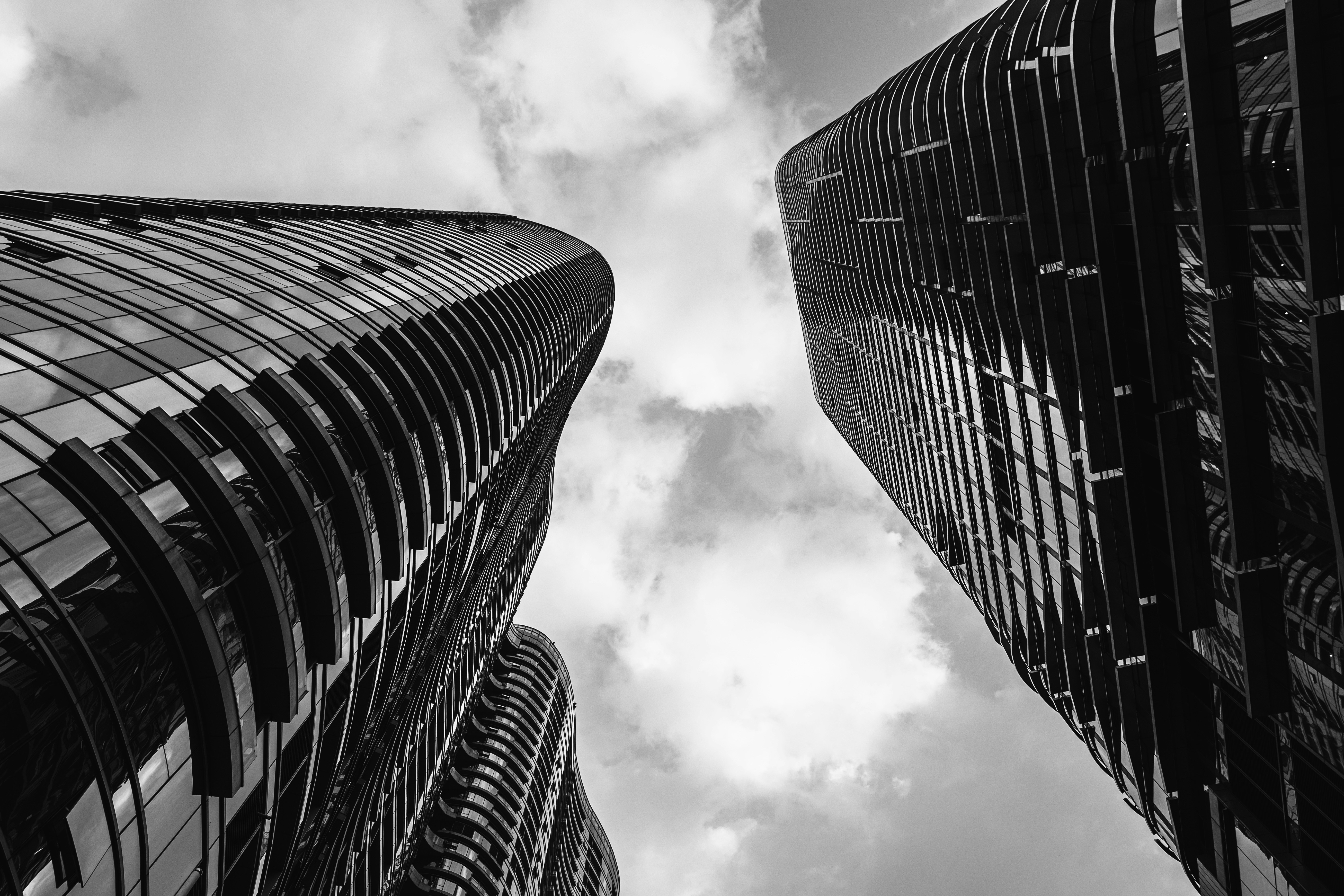 a black and white photo of two tall buildings