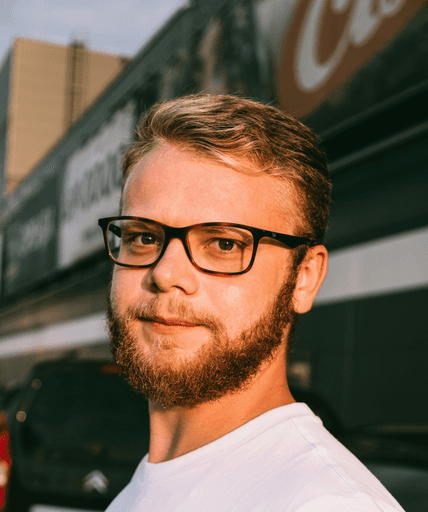 man in white crew neck shirt wearing black framed eyeglasses