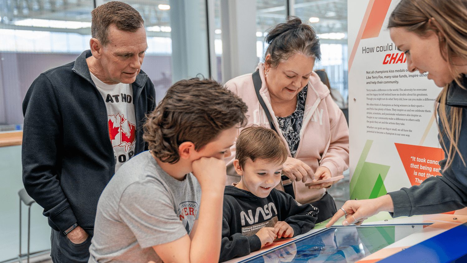 family interacting with touchscreen