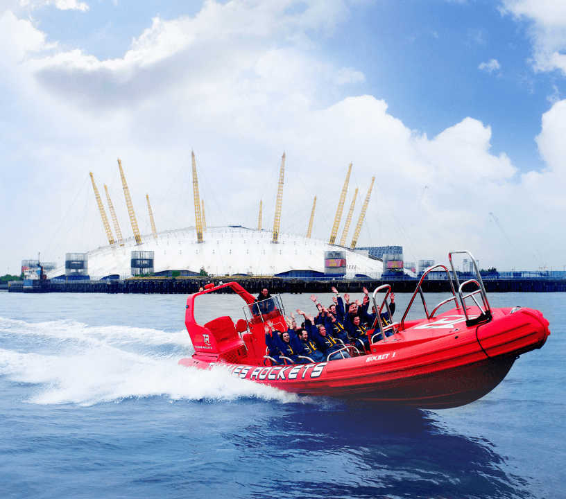 Thames Rockets Speedboat Experience: The sleek red Thames Rocket RIB speeds in front of the O2 Arena