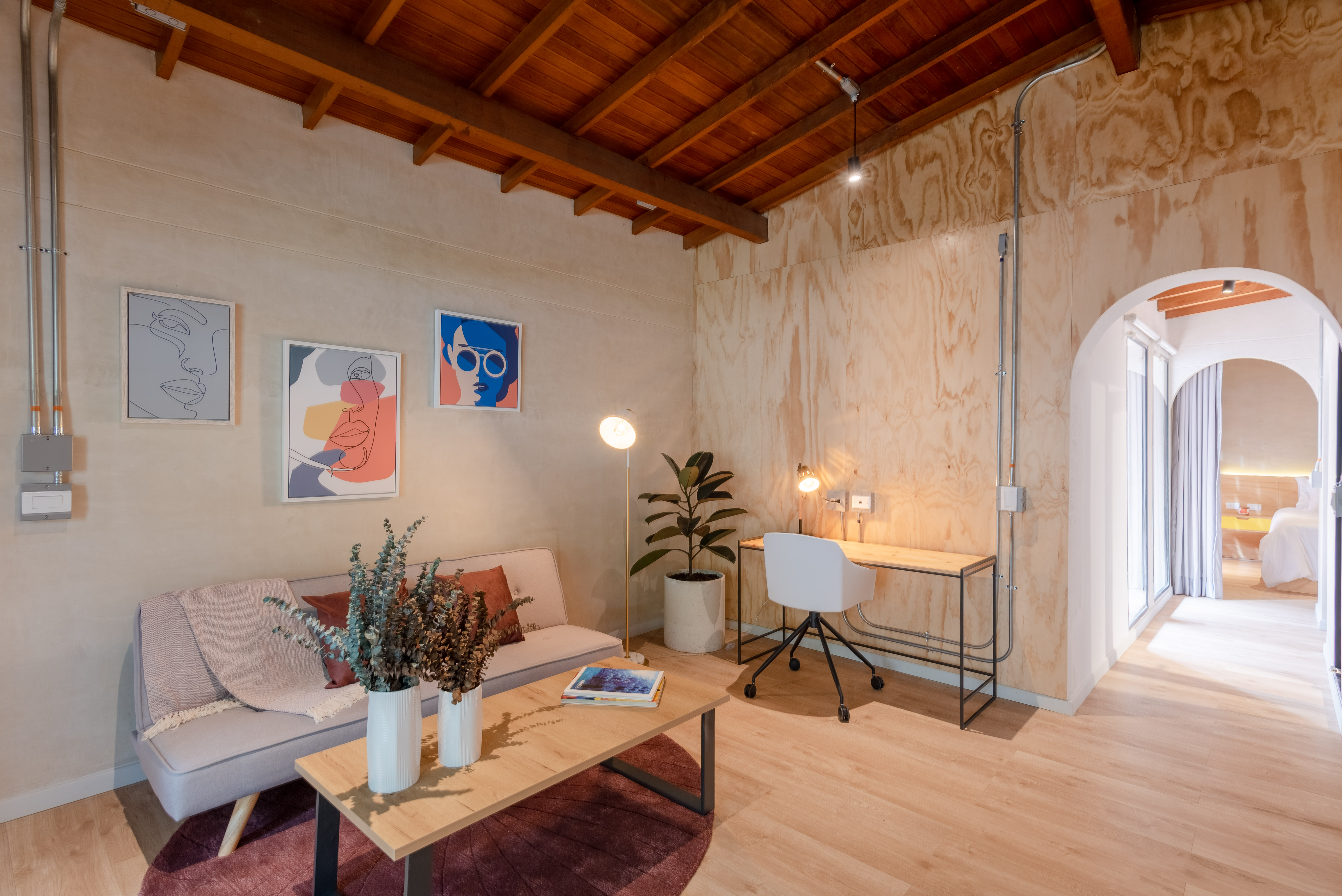 Double-height interior with flowing sculptural forms and warm raking light