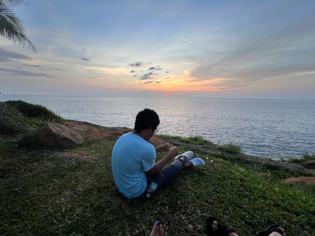A lad enjoying the sunset at Kovalam.