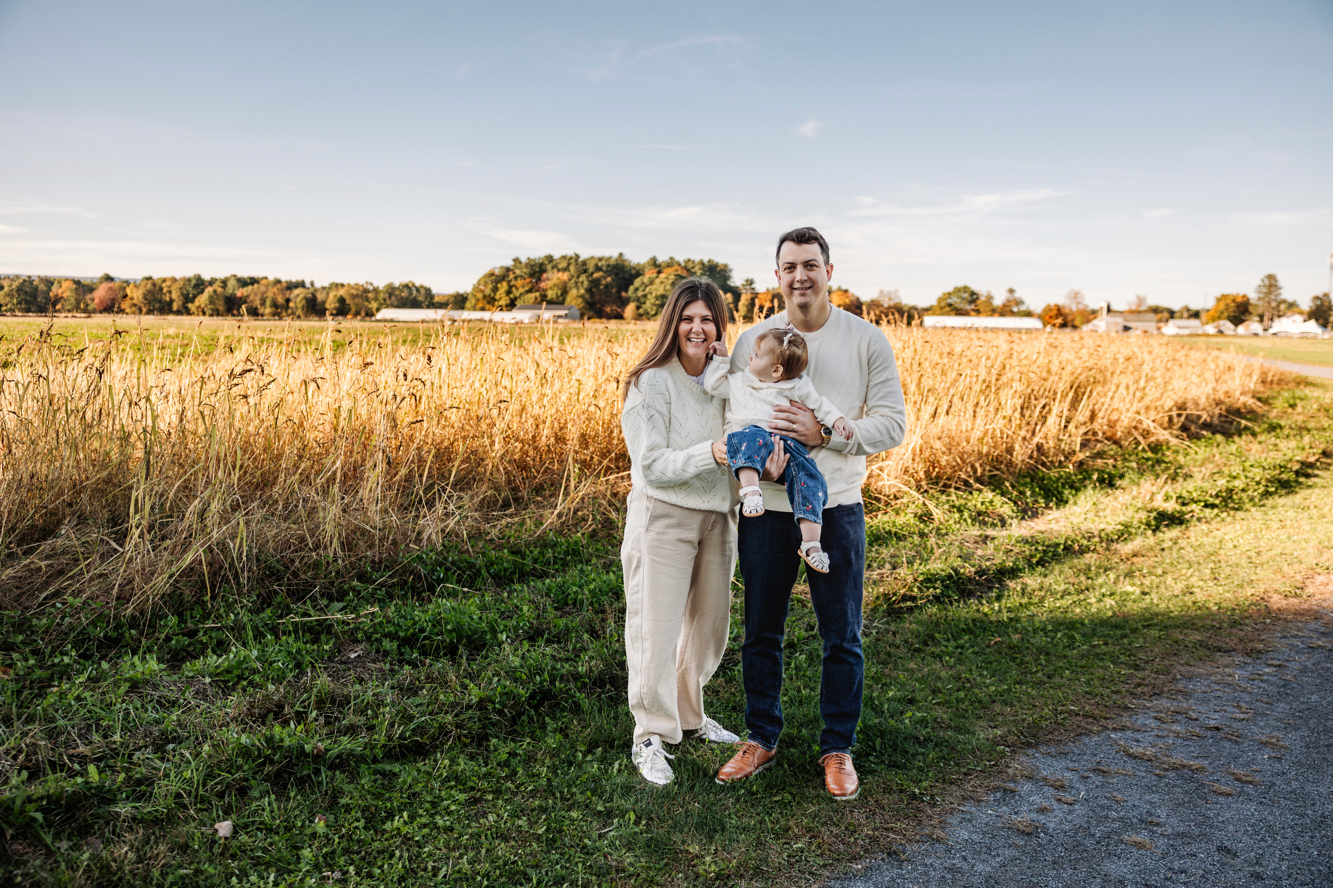 6:13 PMNewly engaged couple sitting on a stoop in the West Village, NYC bathed in warm golden hour light — romantic, candid golden hour engagement photography by Lizz Spano Photography, New York City engagement photographer.