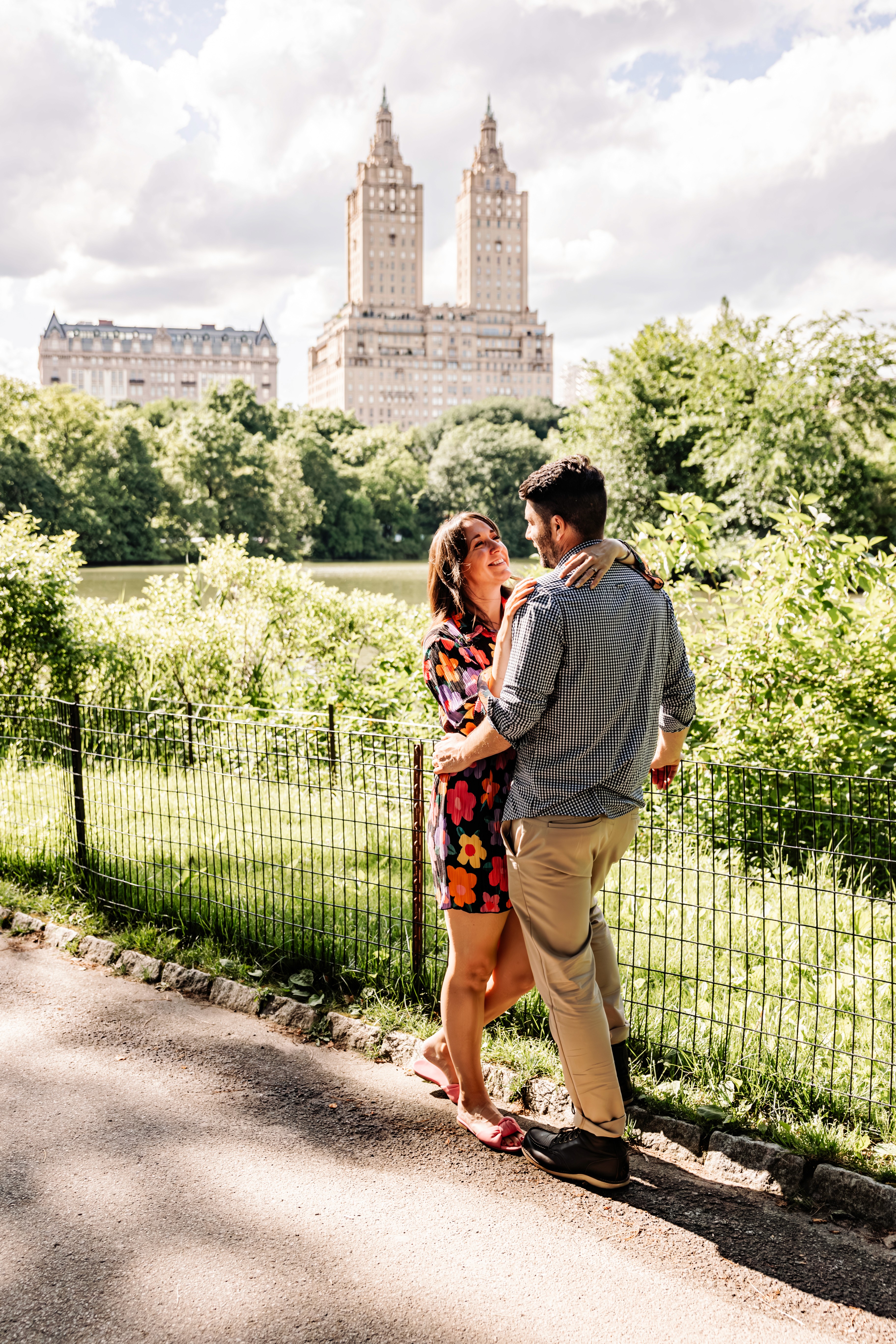 6:13 PMNewly engaged couple sitting on a stoop in the West Village, NYC bathed in warm golden hour light — romantic, candid golden hour engagement photography by Lizz Spano Photography, New York City engagement photographer.