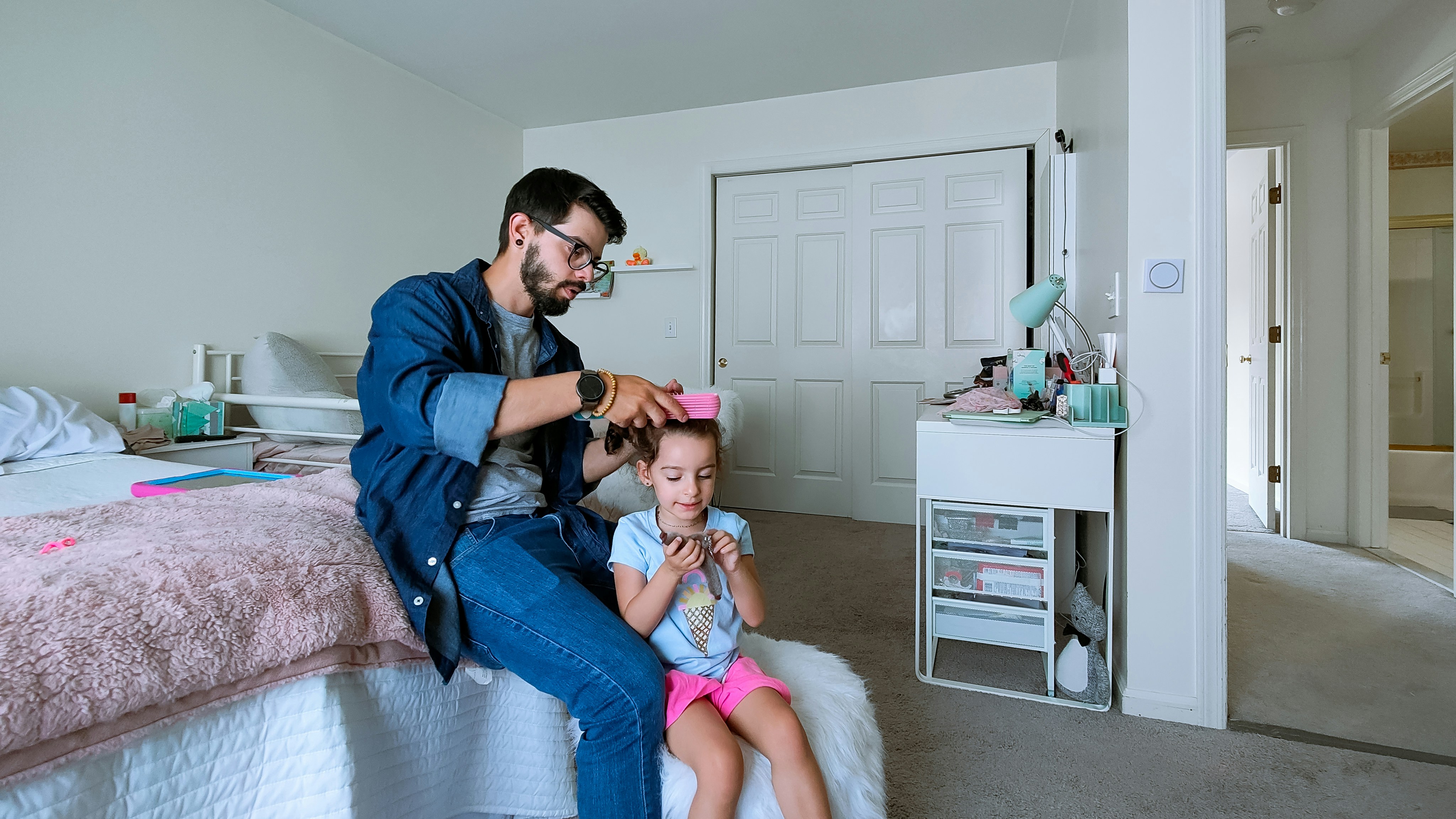 a person and a child sitting on a bed