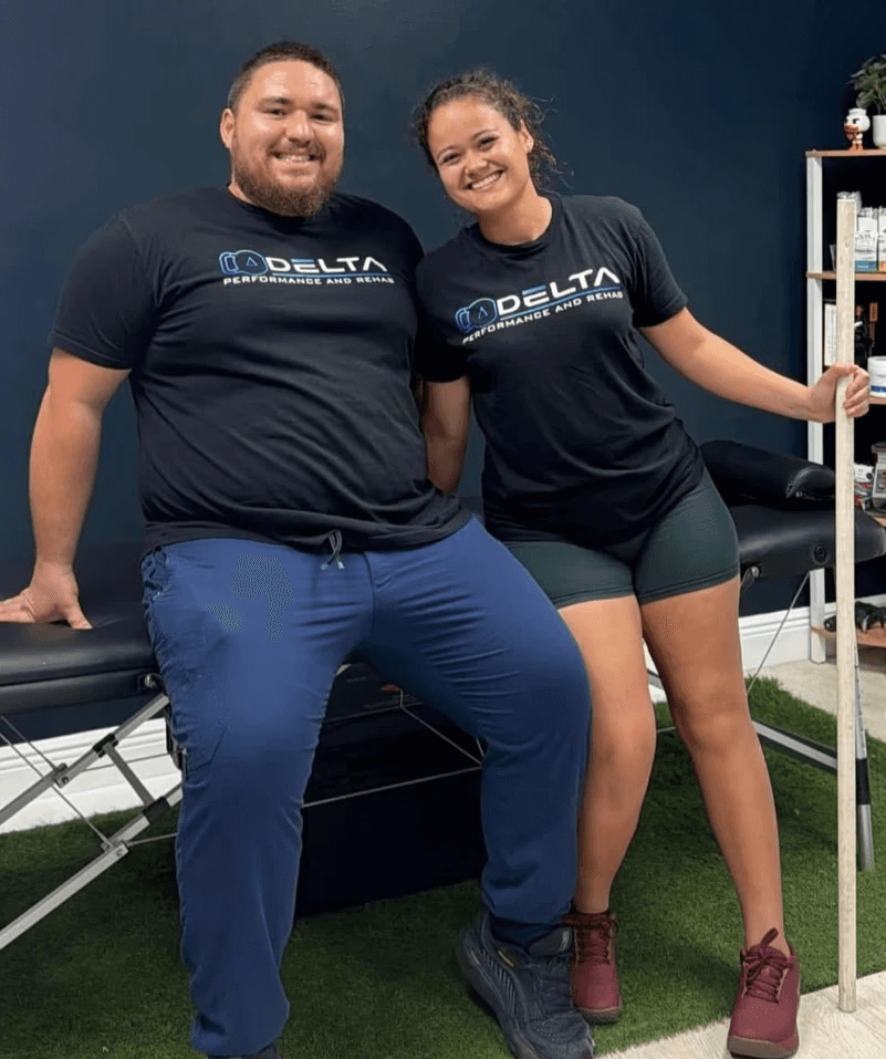 Modern sports rehab and performance training facility with turf lanes, squat racks, and open gym space—ideal for functional movement and strength rehab programs.