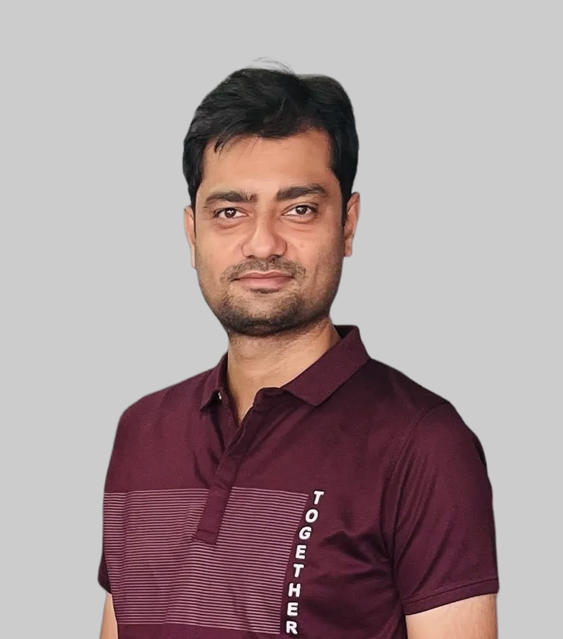 A young man in a white t-shirt stands against a light-colored background.