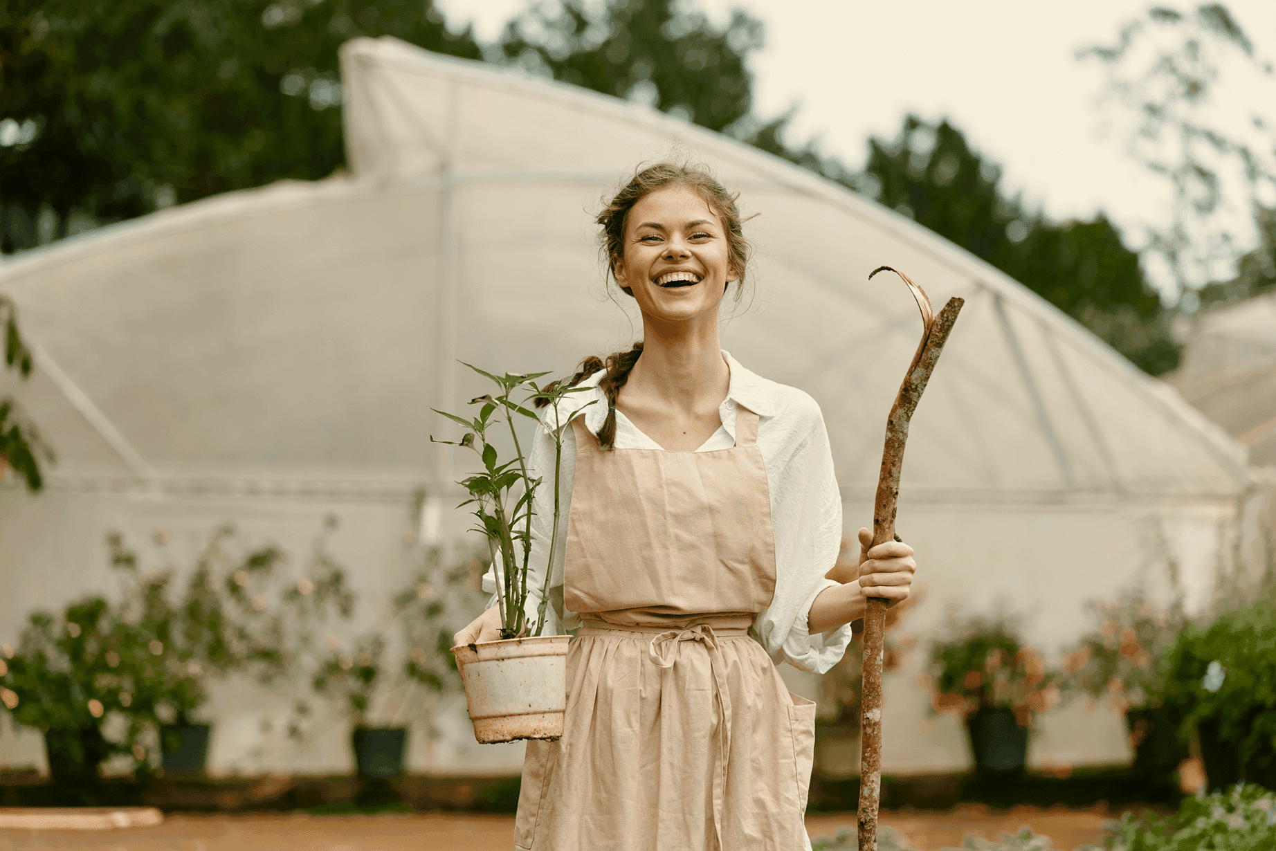 A woman smiling and wearing plants