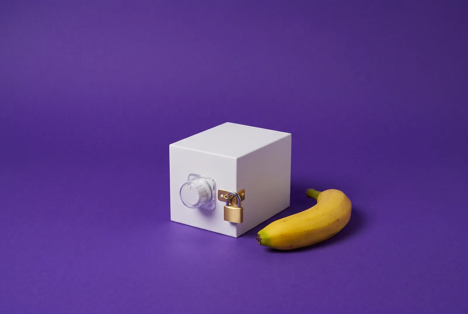 A white box with its knob capped and padlocked beside a banana, ISP routers that lock DNS when you block porn on your router