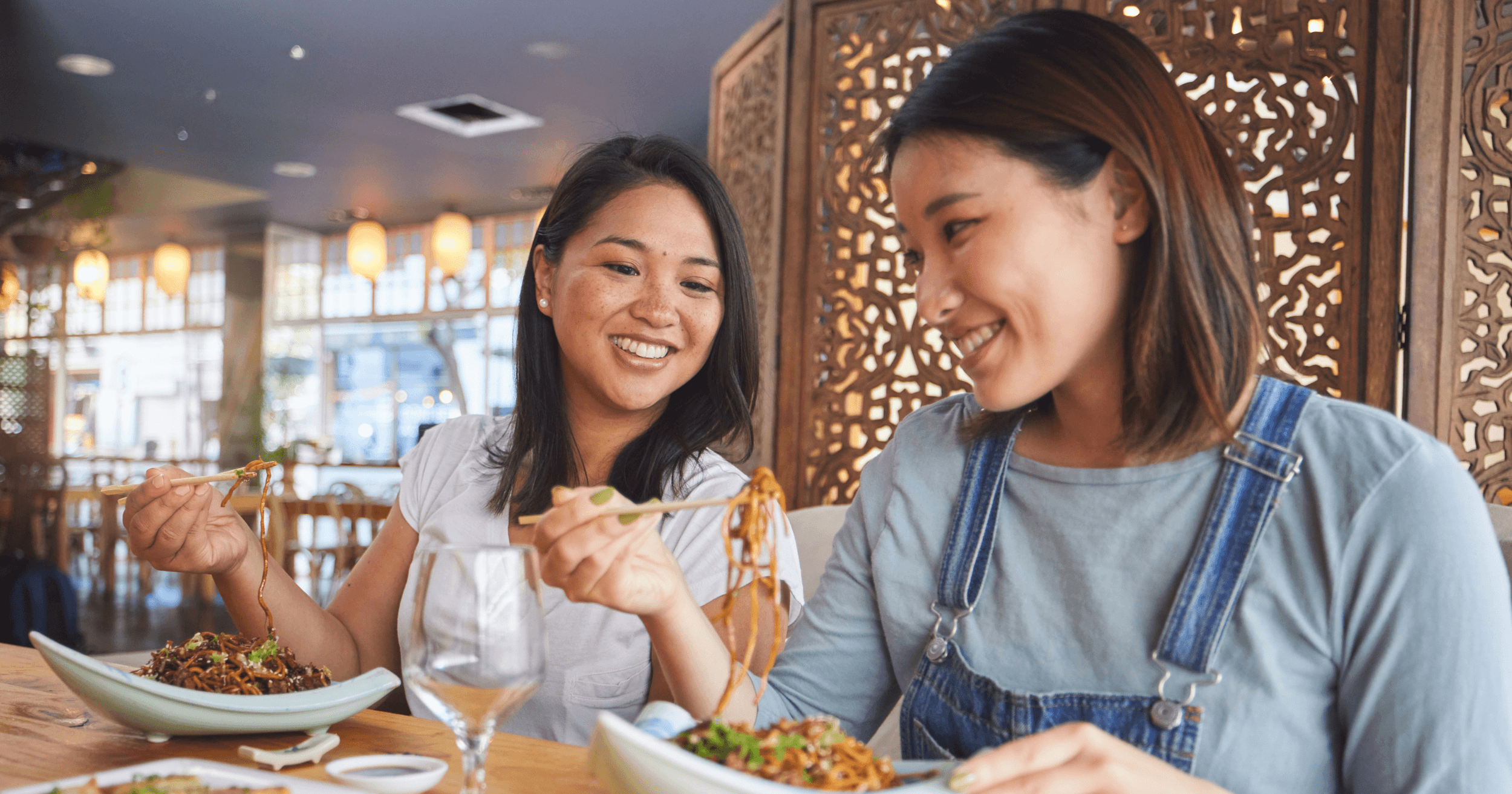 Two women enjoying noodles