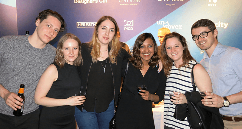 A photo of a group of people standing in a gala exhibition room.