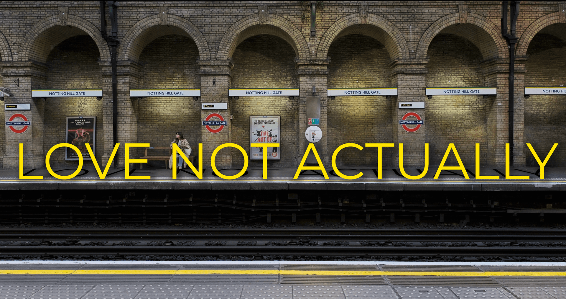 Notting Hill Gate Underground station platform with the title Love Not Actually, from the narrative short film