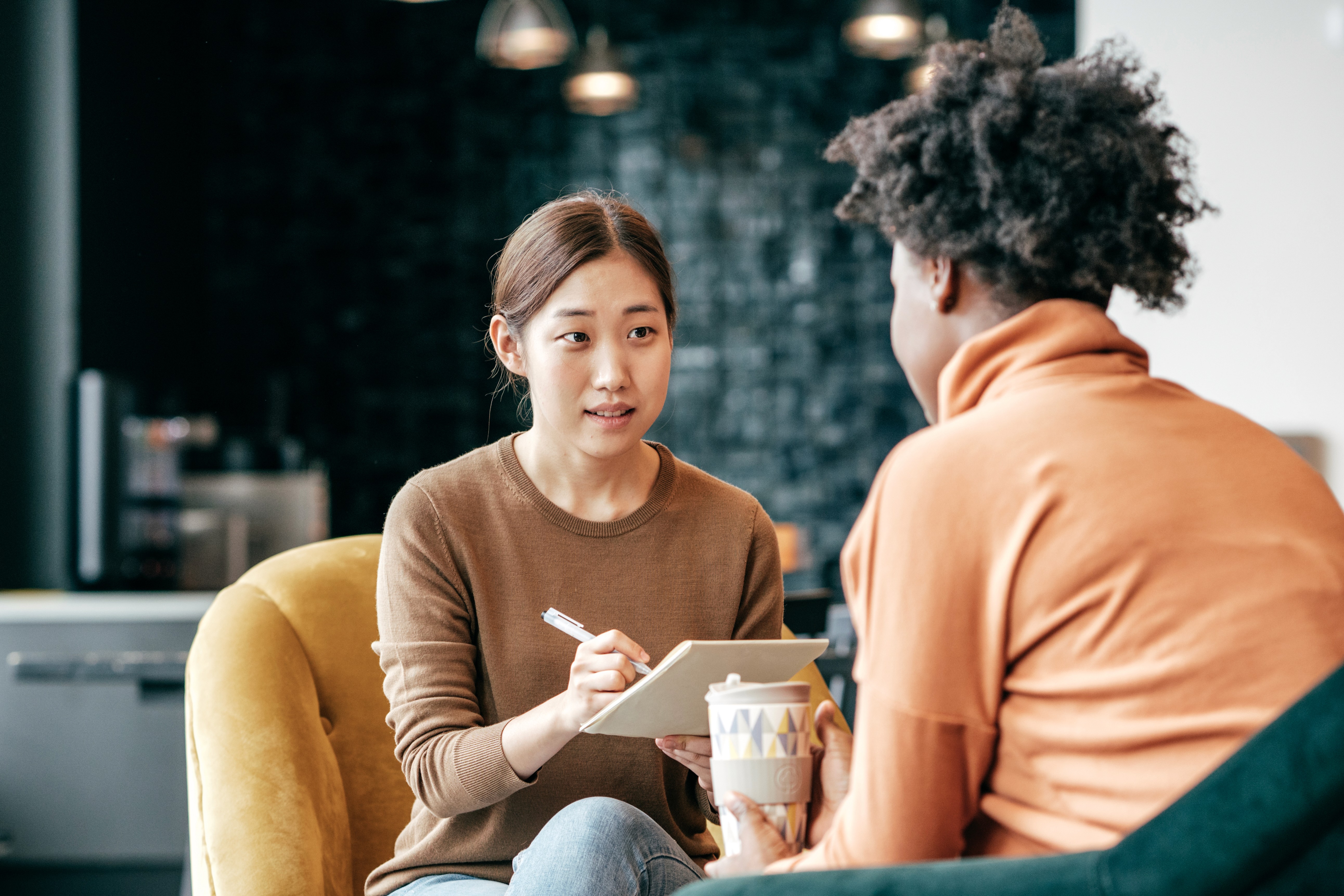 Person in a grocery aisle reading a package while using a phone