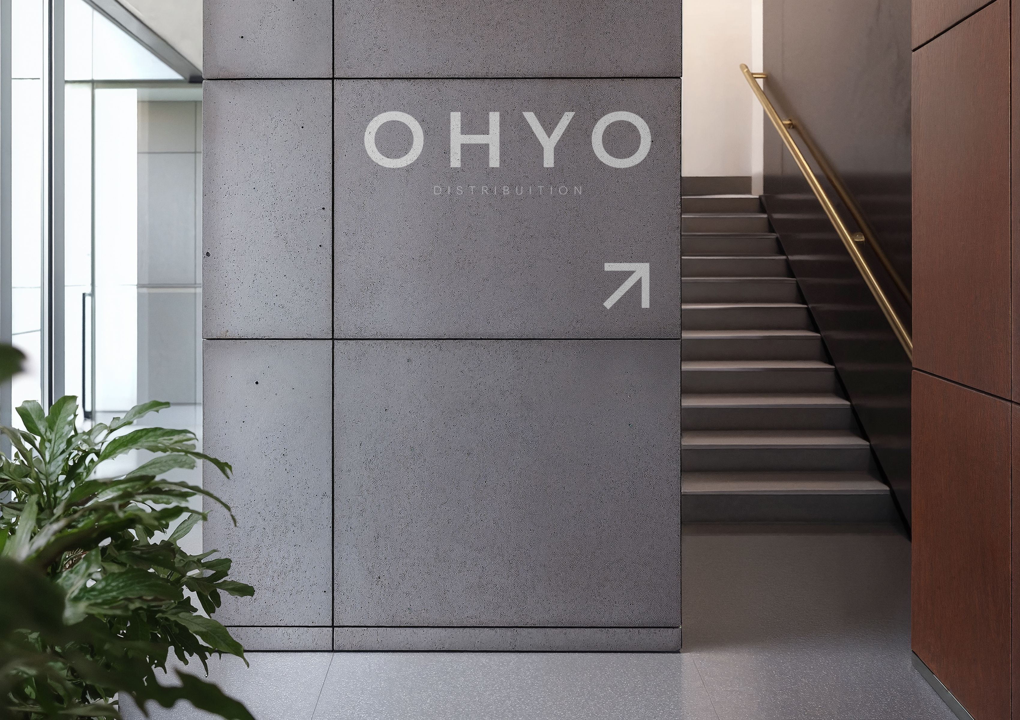  Modern office interior with OHYO Distribution logo signage on concrete wall.