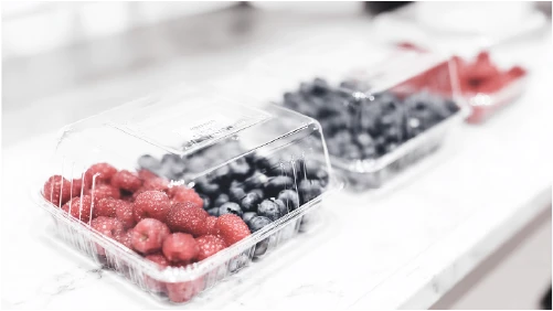 Clear plastic food packaging holding fresh berries.