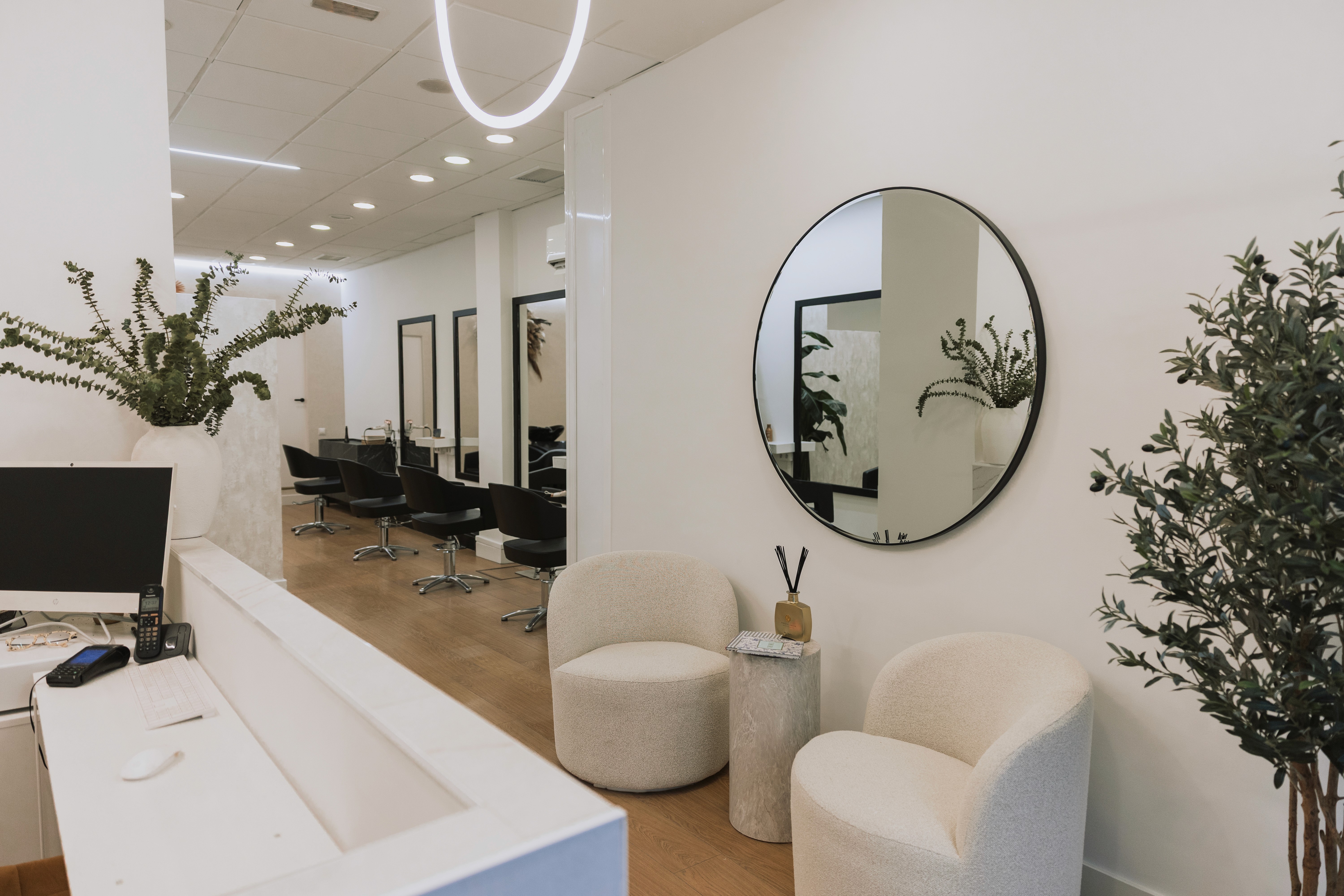 A woman lying down on a soft surface with her eyes closed, bathed in warm sunlight filtering through leaves. Her face has a natural glow, reflecting relaxation and tranquility in a serene spa-like setting.