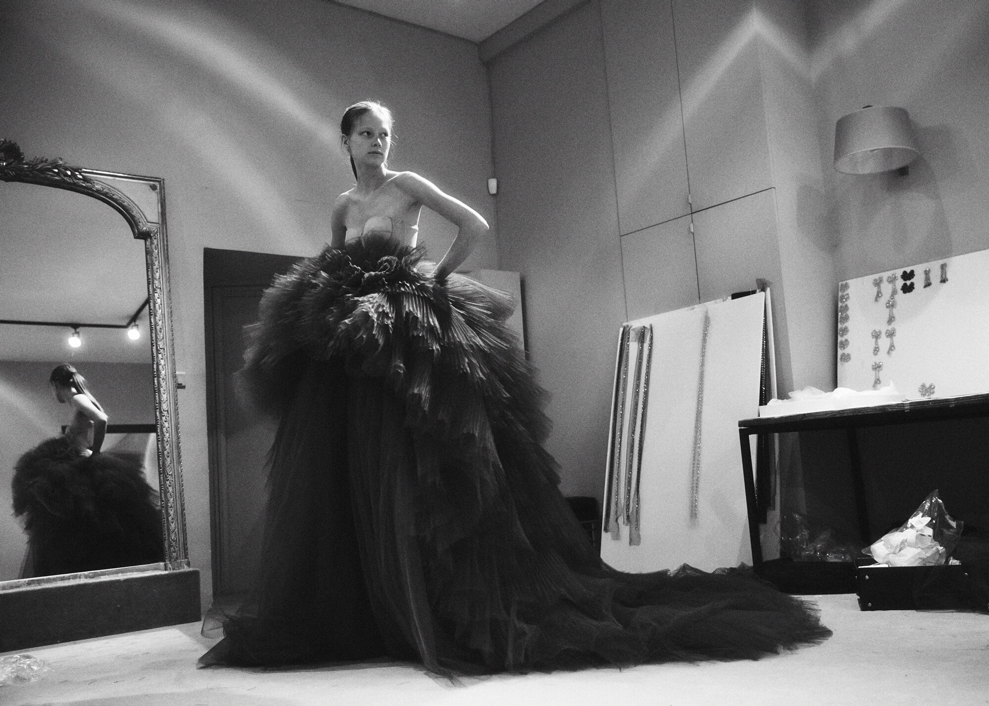 A fast black sports car races down the highway.