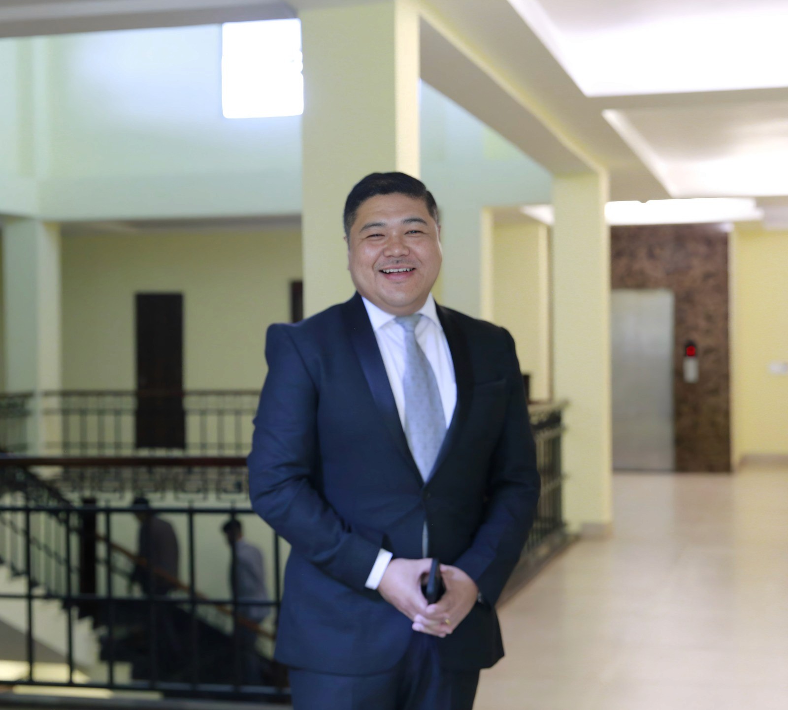 woman in black blazer covering her face with her hand
