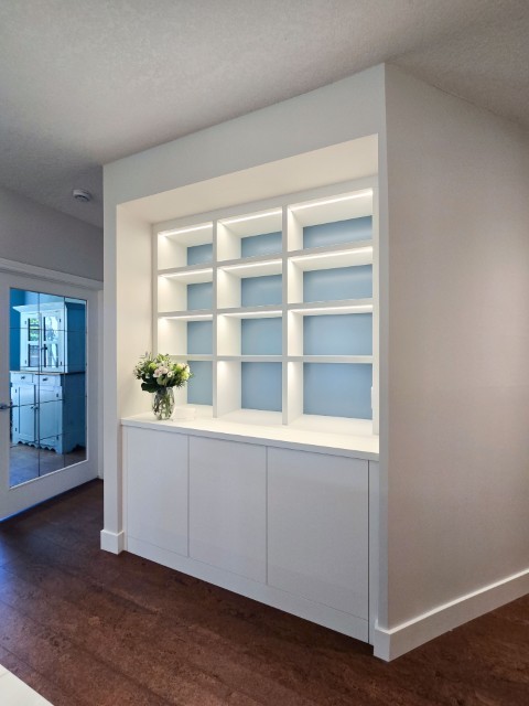 Image of "KHD Homes design-build interior featuring recessed shelving and cabinetry with vase on top of cabinet."