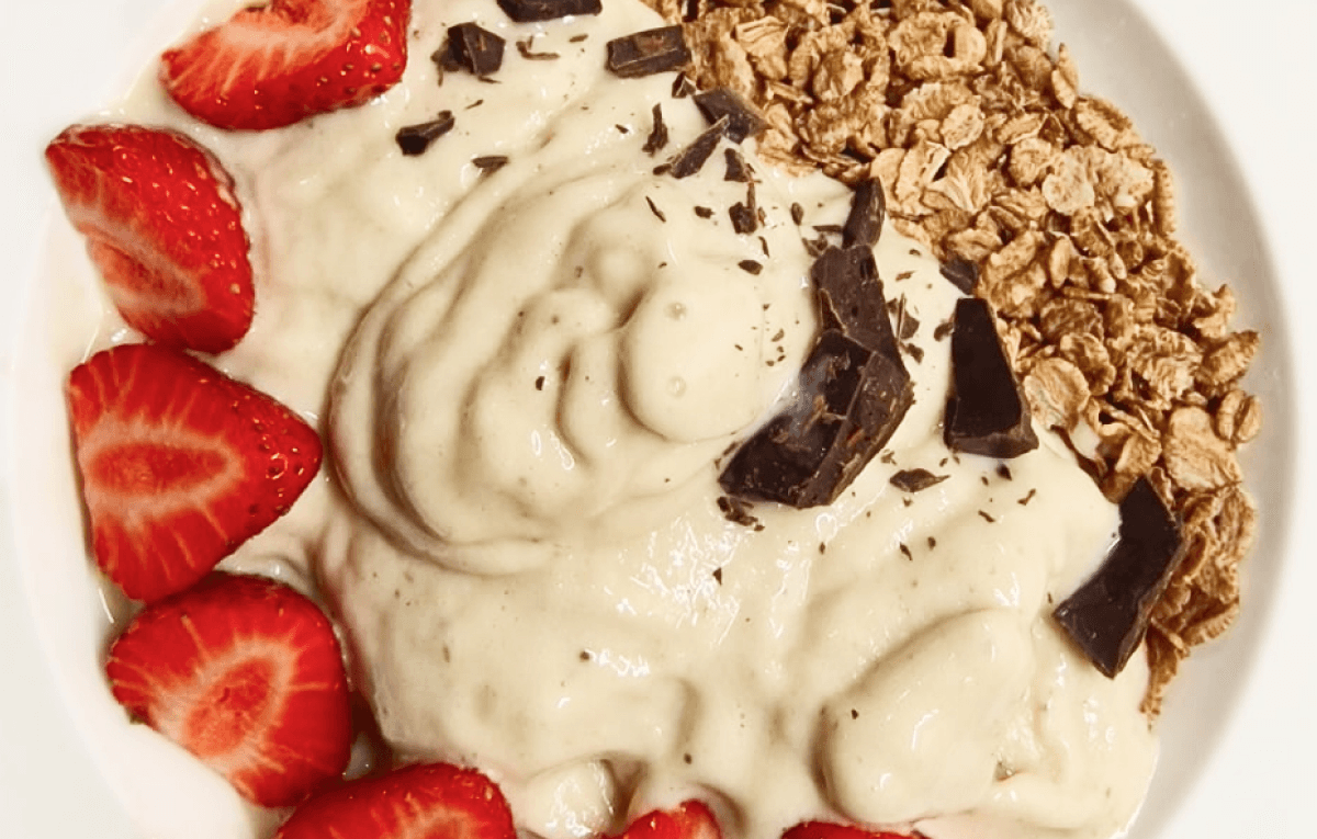 Banana nice cream topped with strawberries, 100% cocoa chocolate and 100% nuts peanut butter
