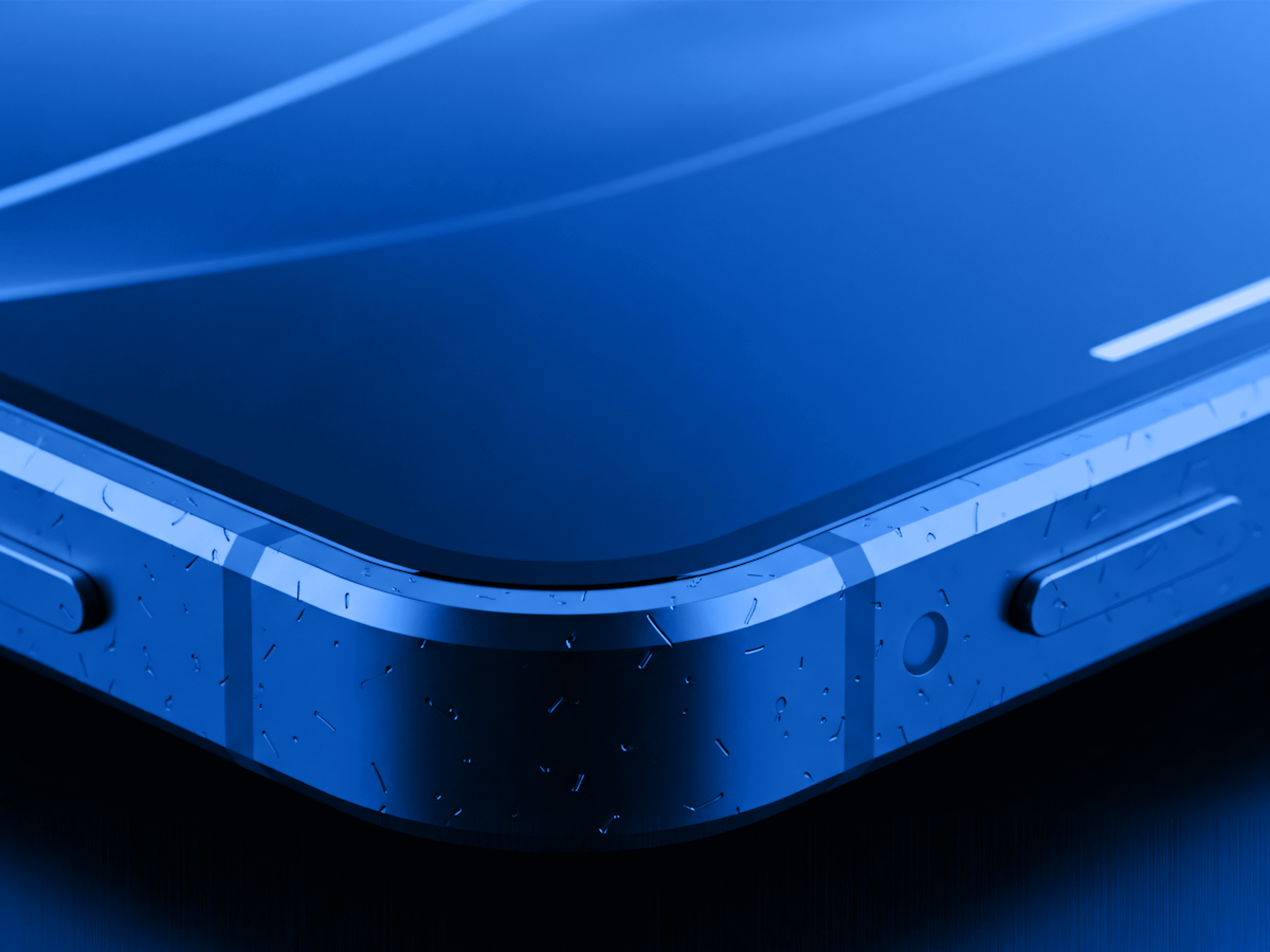 Corner view of a sleek smartphone with water droplets on its matte blue frame.