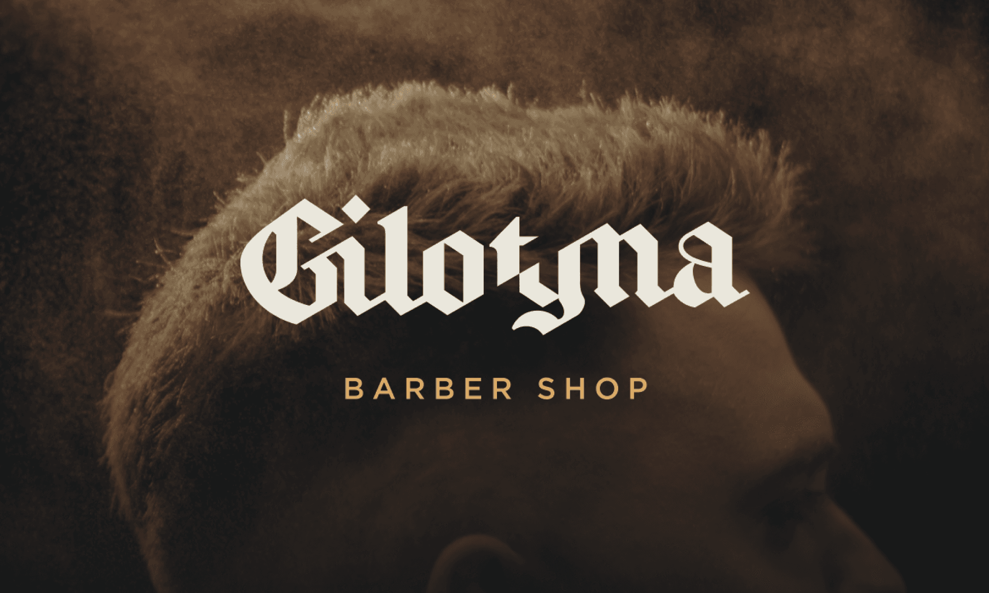 Gilotyna Barber Shop logo over a close-up of a fresh haircut
