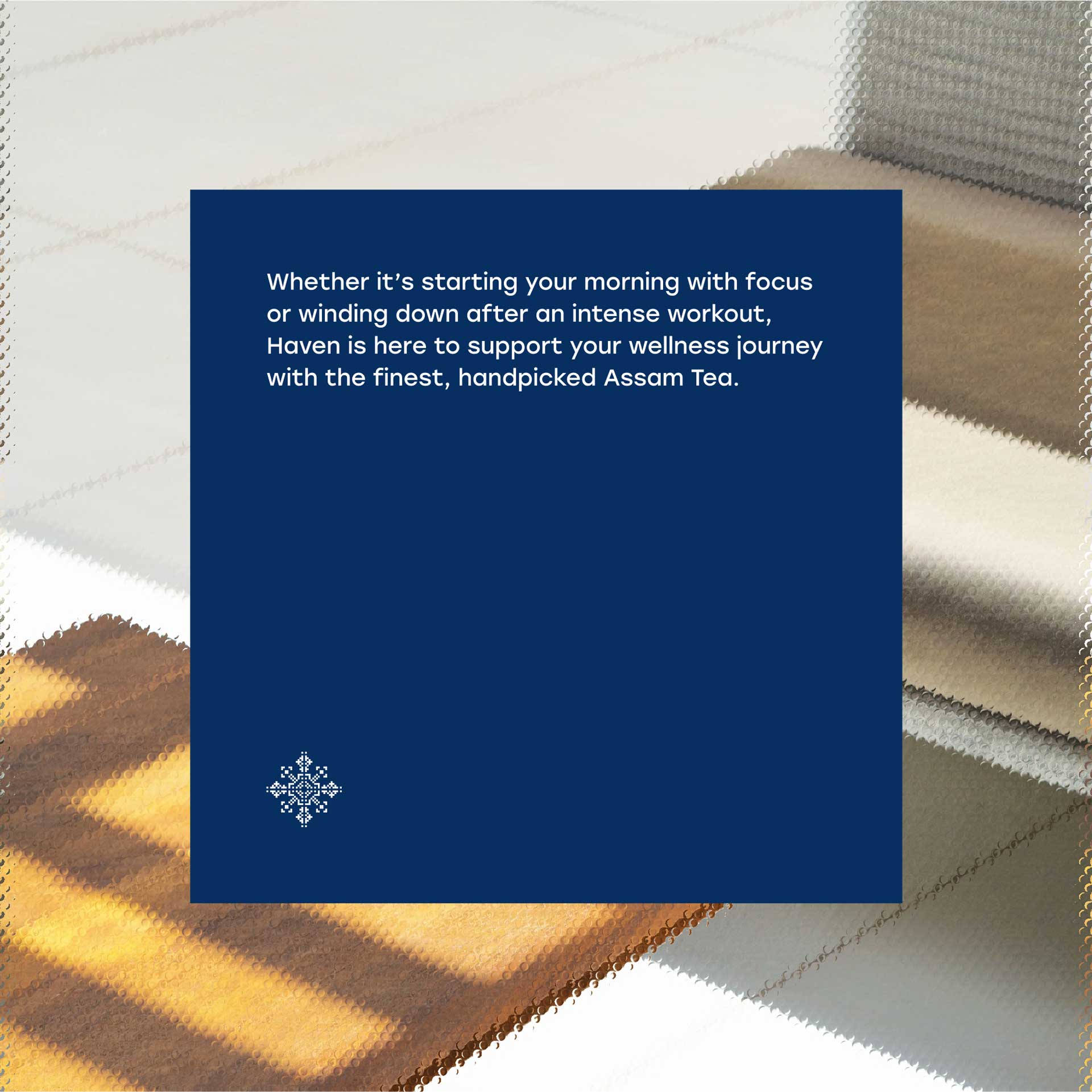A blue promotional poster about Assam Tea is placed on a blurred background of fuzzy brown and beige fabric textures, highlighting a message about wellness, focus, and relaxation.