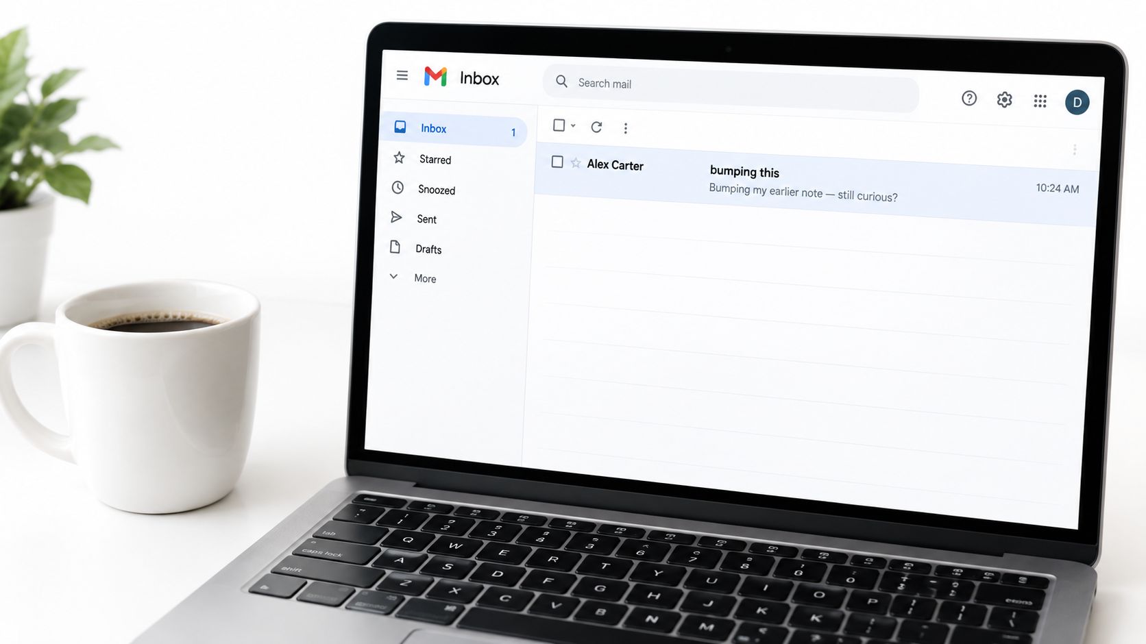 A modern laptop on a desk showing an inbox with a follow-up email about a business request.