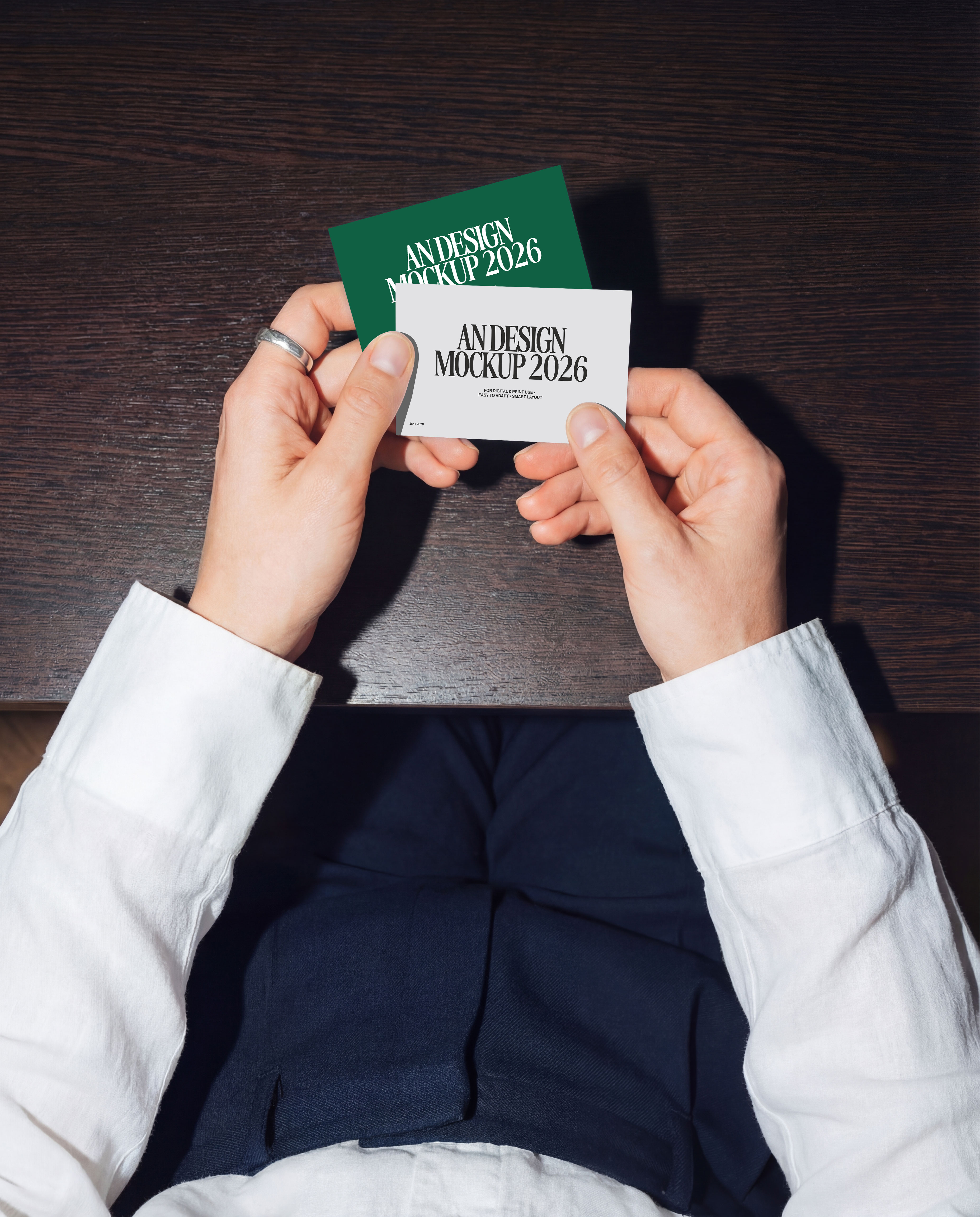 Hand holding business card mockup on office table