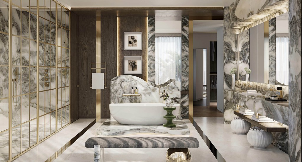 A luxurious bathroom featuring marble walls and gold accents, located in the Lanai Islands, Dubai.