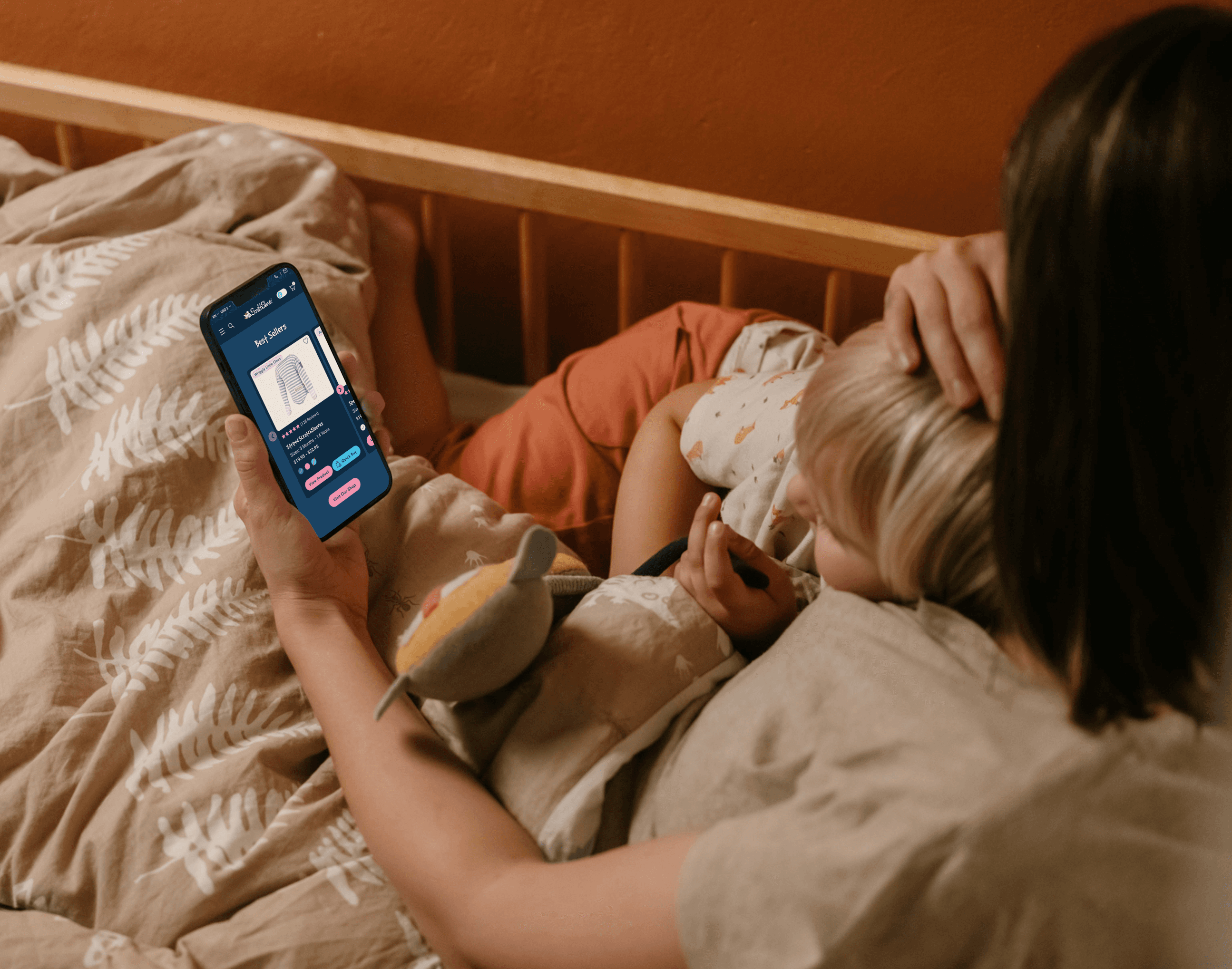 Mother holding phone, cradling baby, night mode phone