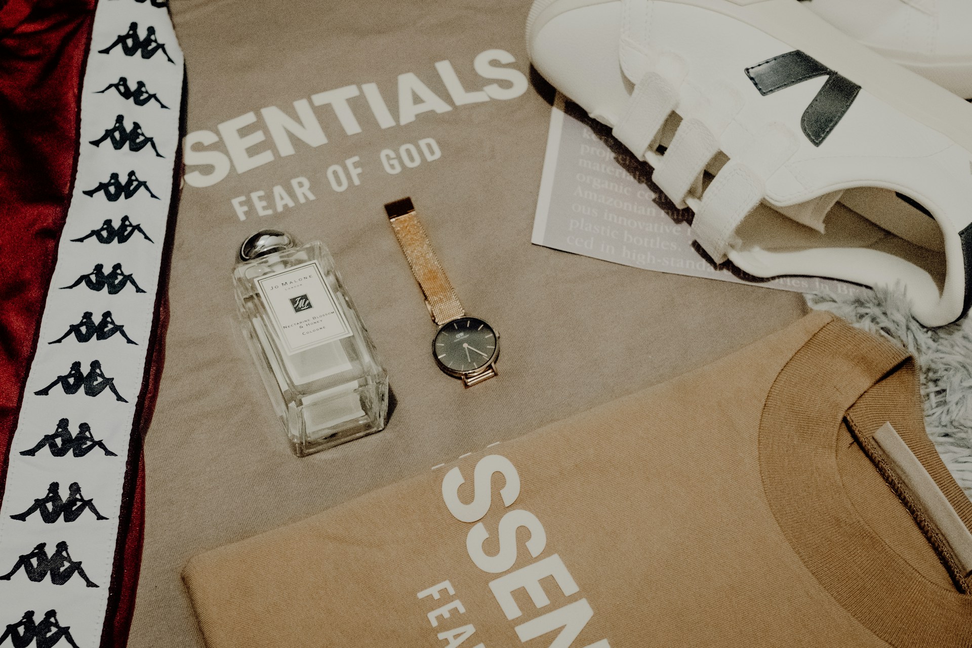 streetwear brands laid out showing a watch, sneaker, shirts and perfume