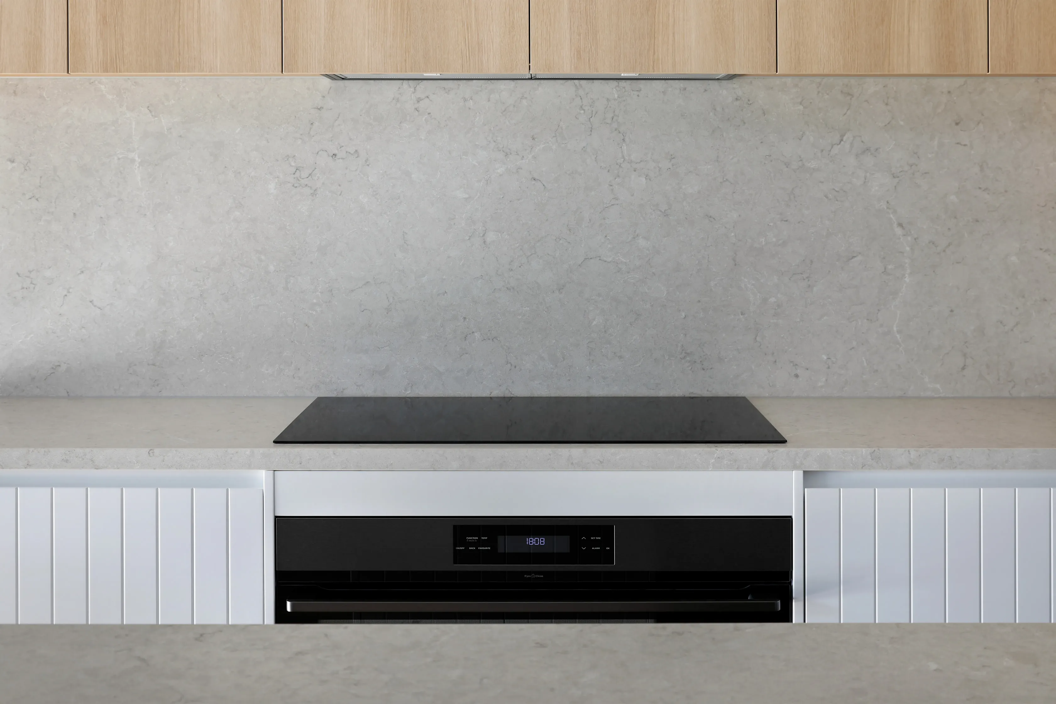 Kitchen detail with a black induction cooktop set in a grey stone benchtop, a full-height stone splashback and pale-oak overhead cabinetry, with an integrated oven below