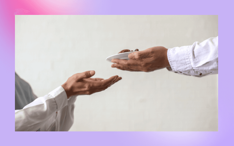 Two individuals performing a hand-to-hand charitable transaction, symbolizing the Islamic act of Zakat and its role in validating other deeds.