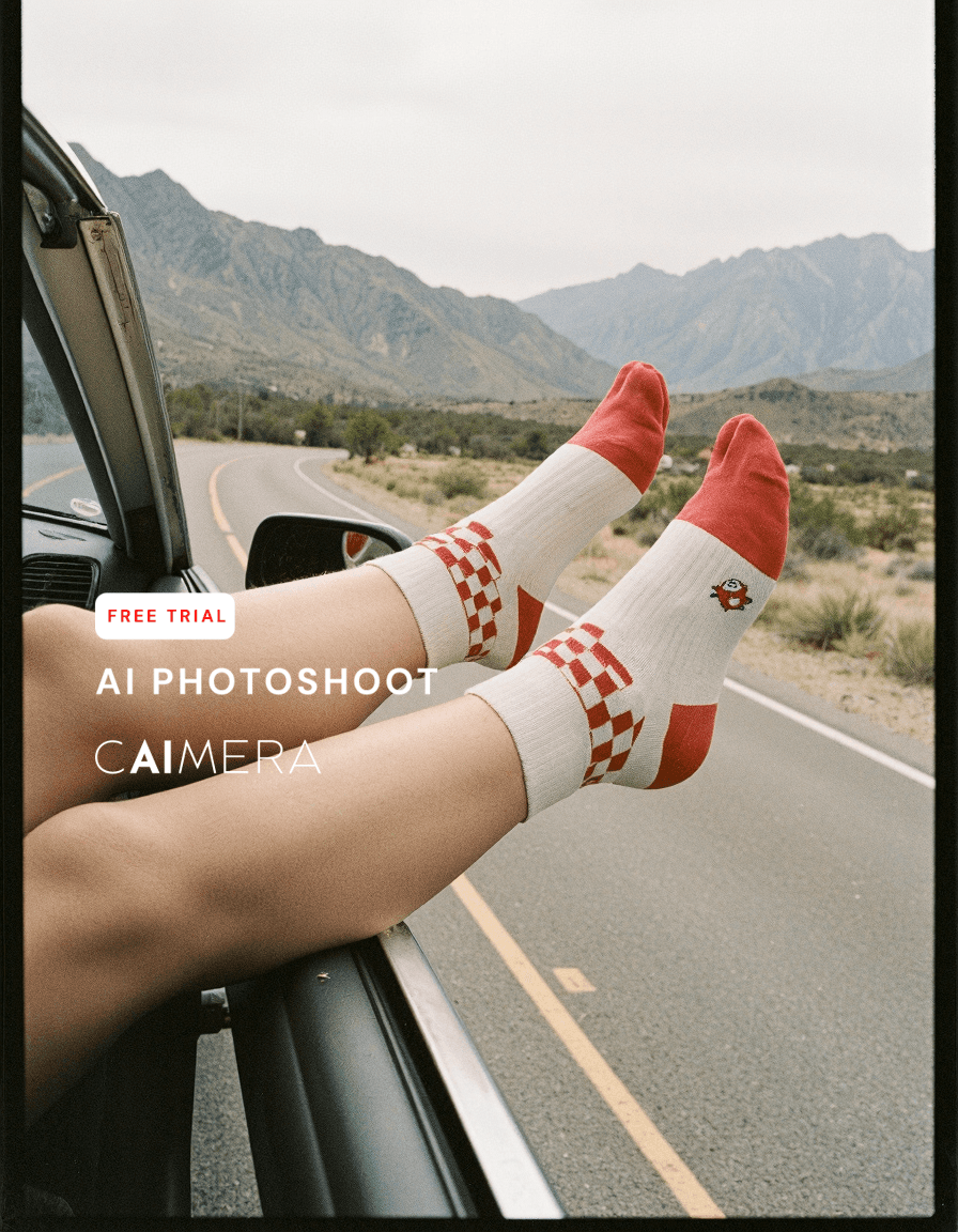 Legs wearing red and white checkered socks hanging out of car window on desert highway with mountains in background