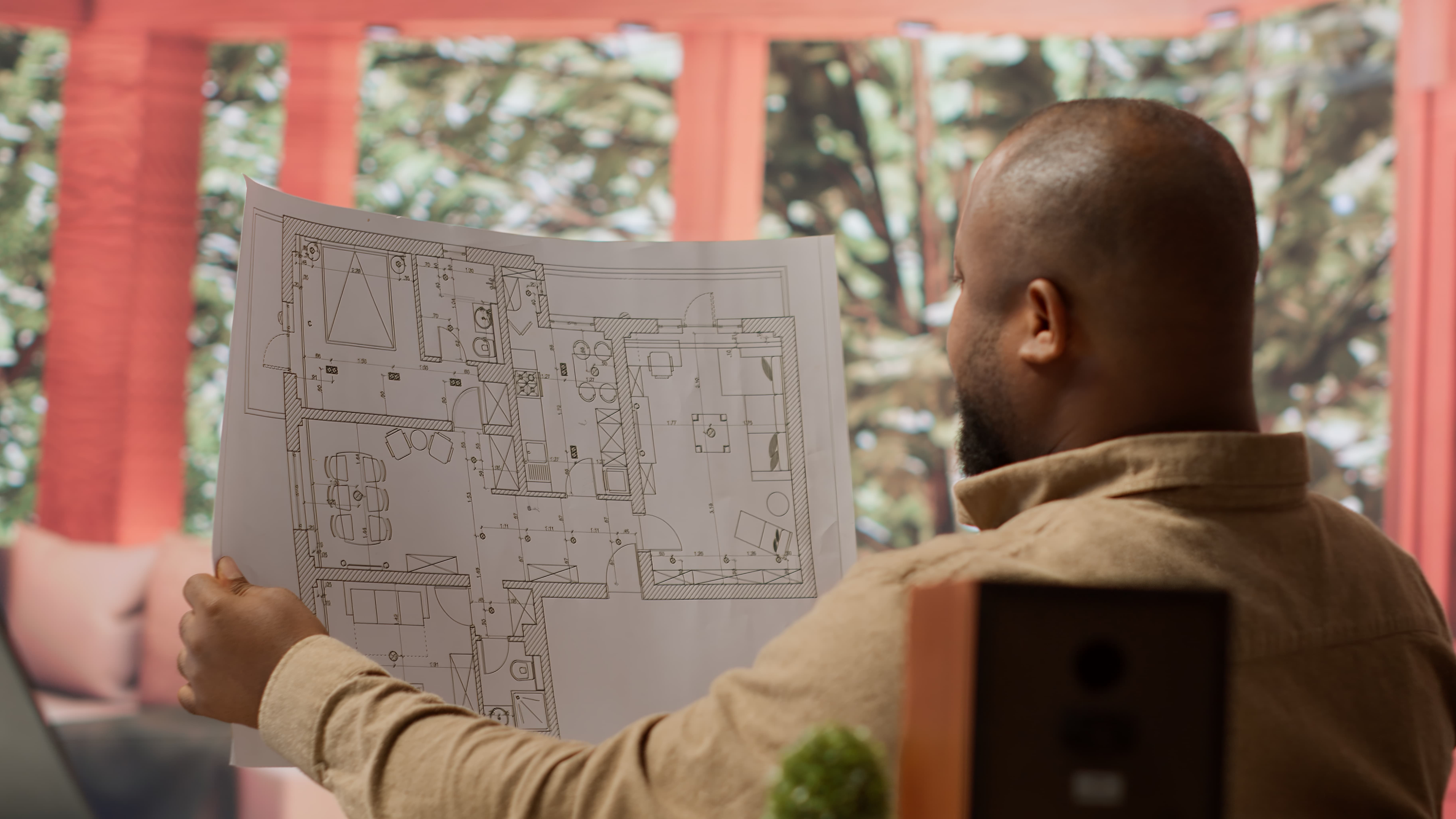 man looking at building plans