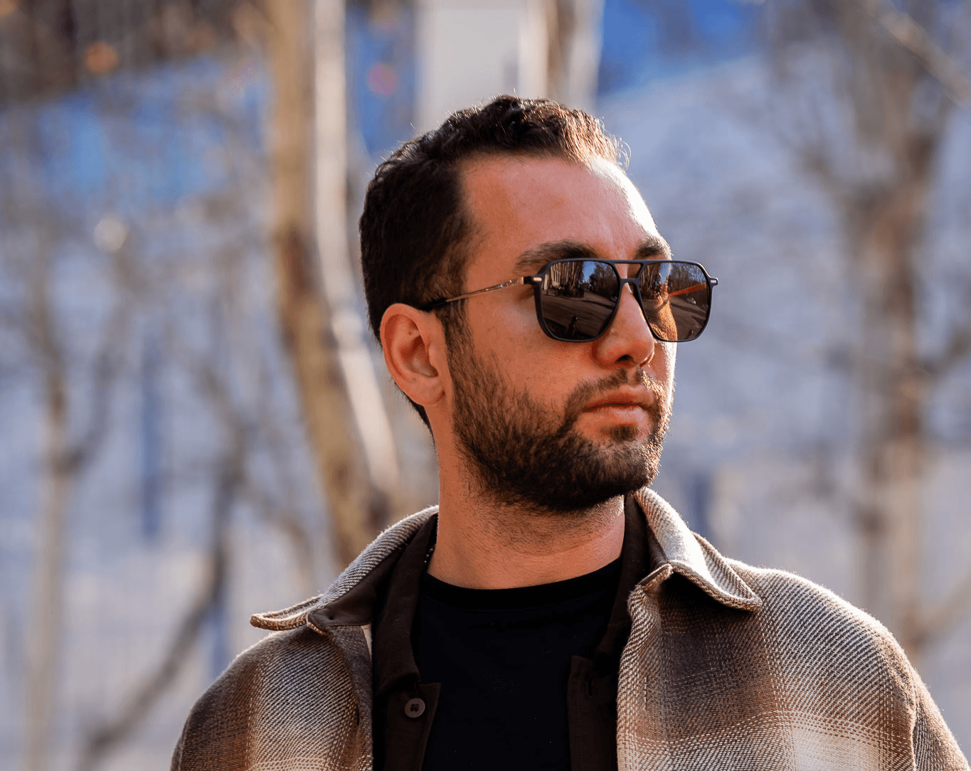 Profile portrait of a man in a grey shirt