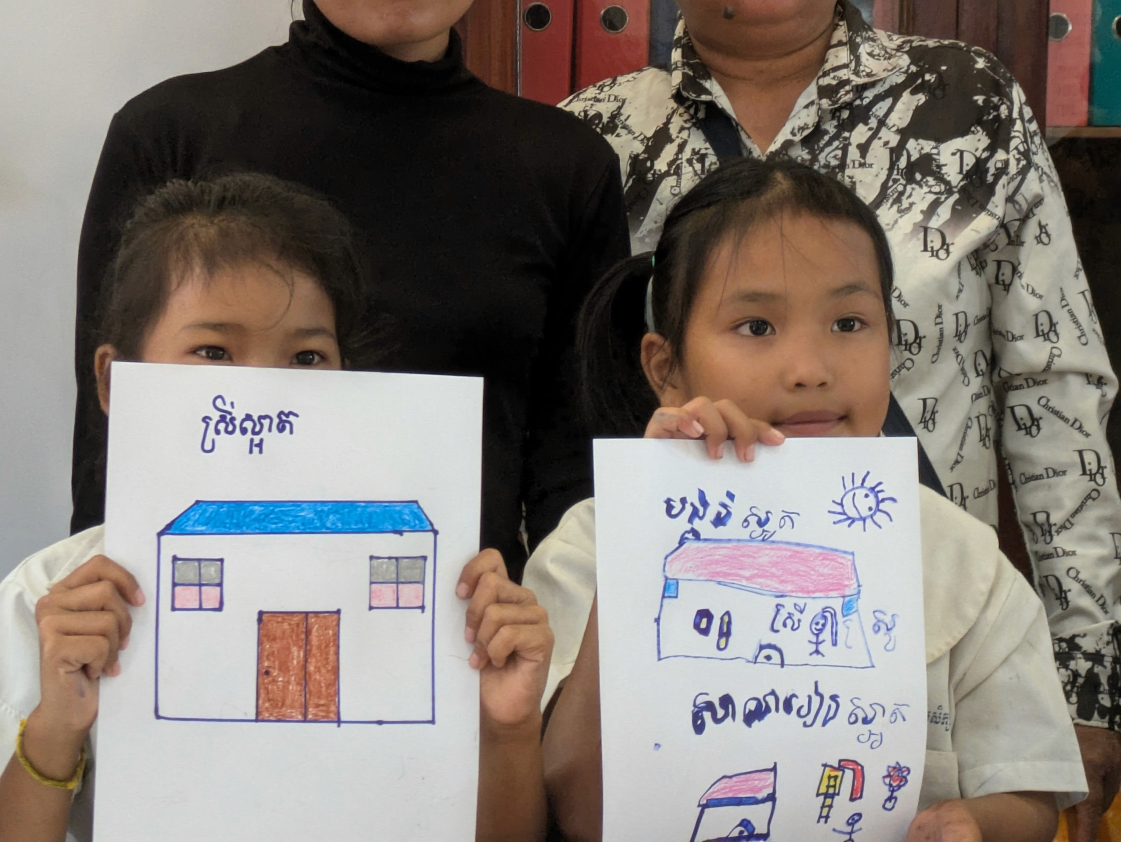 2 Kids showing their art