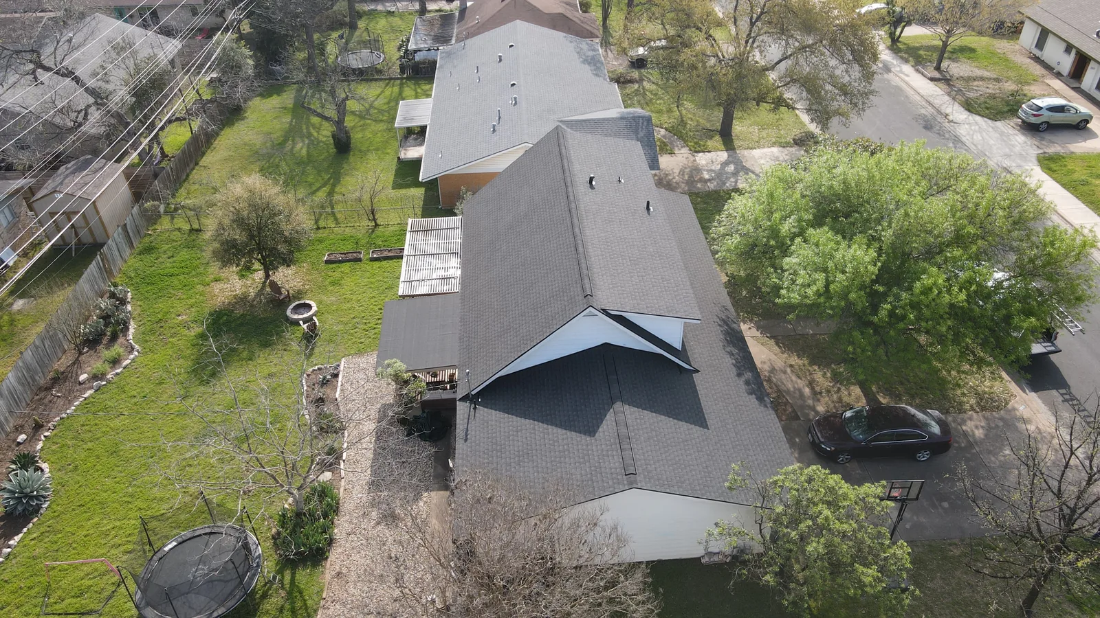 After - another angle: metal to dark shingles.