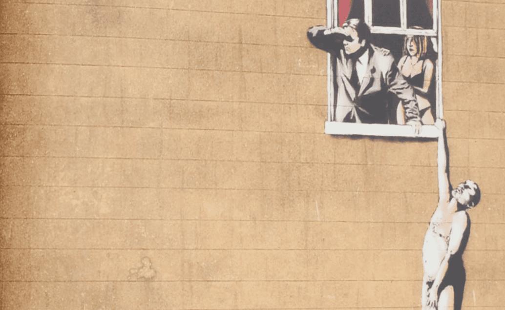 A person stands in a sandstone cave.